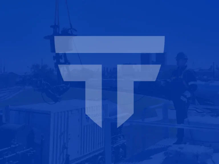 A worker stands on industrial equipment outdoors, with the Transnet logo prominently overlaid on the image.